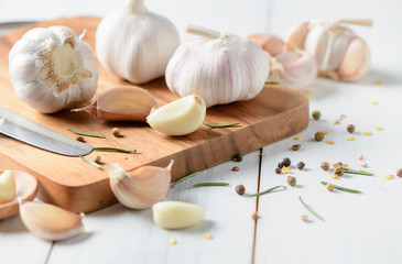 Garlic on wood block and white wood