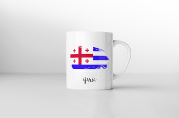 Ajaria flag souvenir mug on white background. 3D rendering.