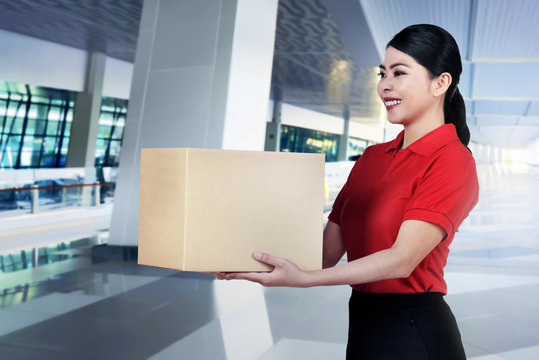 Beautiful asian courier woman bring the parcel