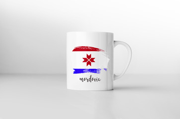 Mordovia flag souvenir mug on white background. 3D rendering.