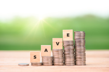 Wooden block with a SAVE word on stacked coins - Business Concept,money saving financial concept
