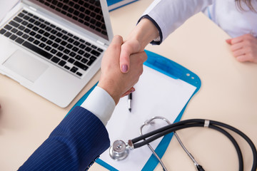 Man signing medical insurance contract