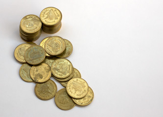 piles coins on white background.