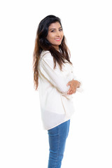Studio shot of young happy Persian woman smiling and standing wi