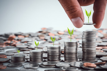 Male hand putting coins with money stack step growing growth saving money, Concept finance business...