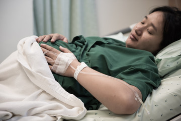 hand of Woman patient admitted to the hospital with saline intravenous (iv)