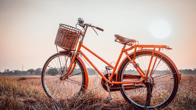 beautiful landscape image with Bicycle at sunset