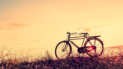 Fototapeta na wymiar beautiful landscape image with Silhouette Bicycle at sunset in vintage tone style