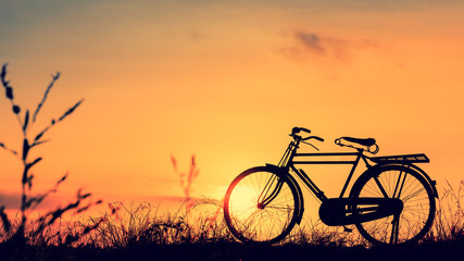 Fototapeta na wymiar beautiful landscape image with Silhouette Bicycle at sunset in vintage tone style