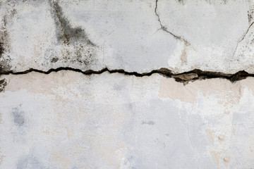 Crack texture on old white cement wall, dirty wall, construction concept background, damaged concrete wall