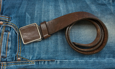 a rolled-up belt on blue jeans.