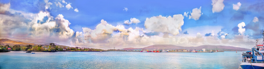 Panoramic landscape with cumulus clouds and ships in a county Kerry