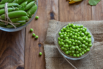 a lot of peeled small green young peas in a bowl on the table