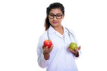 Studio shot of young beautiful Persian woman doctor looking at r