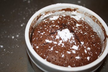 Chocolate souffle with powdered sugar straight out of the oven