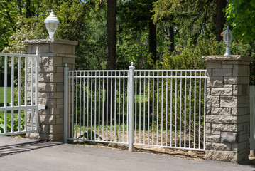 Two pillars and a white metal fence