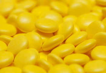 Fototapeta na wymiar yellow pills background