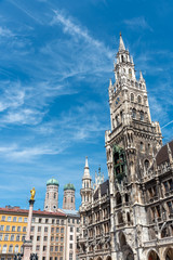 Fototapeta na wymiar The New City Hall at the Marienplatz in Munich with the towers of the Frauenkirche in the back