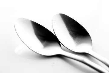 Spoon background / A spoon is a utensil consisting of a small shallow bowl oval or round, at the end of a handle