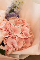 Beautiful spring bouquet with tender pink ranunculus and hydrangea flowers, elegant floral decoration