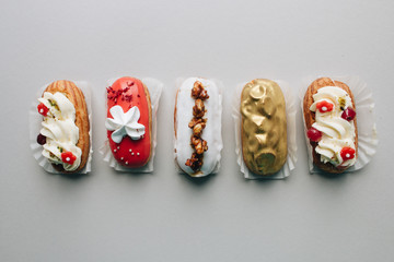 Assorted delicious sweets on grey background