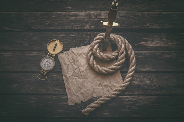 Compass, crumpled brown paper page parchment with copy space for treasure map for example and the...