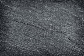 Dark grey black slate stone background or texture.