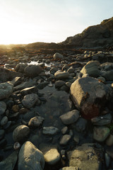 Fototapeta na wymiar low tide tide pools exposed at sunset