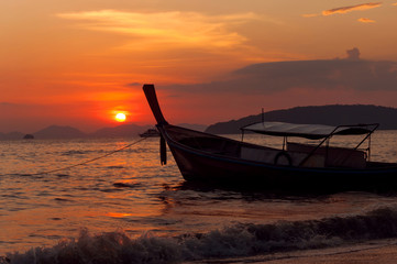 small boat at sunset