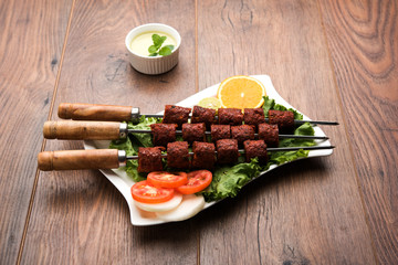 Indian Mutton Seekh Kabab served with green salad, selective focus