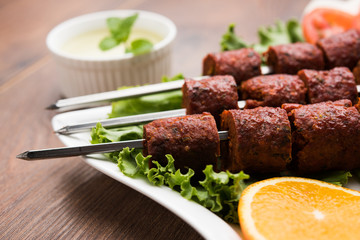 Indian Mutton Seekh Kabab served with green salad, selective focus
