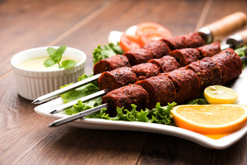 Indian Mutton Seekh Kabab served with green salad, selective focus