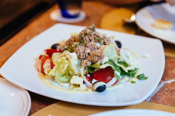 Italian tuna salad including cabbage, tomato, olive and tuna.