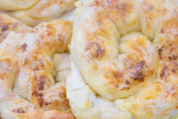 Baked snack with stuffing with golden crust. Traditional moldavian food called platzinda