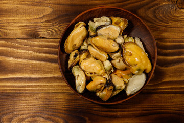 Marinated mussels on wooden table