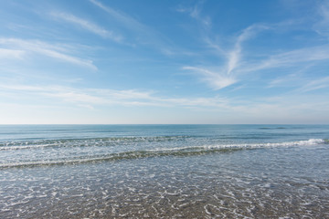 waves, sea and sun reflecting from the beach - background