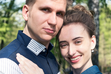 Bride and groom in a park. Kissing couple newlyweds bride and groom at wedding in nature green forest are kissing photo portrait.Wedding Couple Wedding ceremony concept.