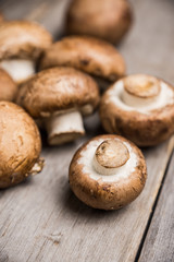 Fresh mushrooms on the rustic wooden background. Selective focus. Shallow depth of field.