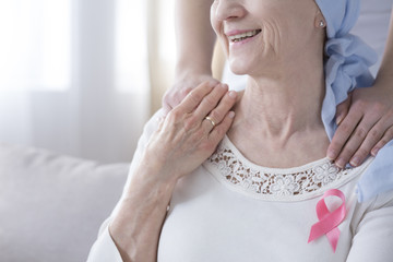 Smiling elderly woman with cancer
