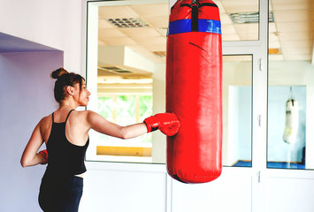 sexy fighter girl punching actively. Motion long hair.