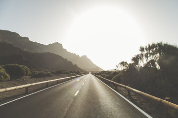 Road to El Teide volcano peak. Travel by car. Volcanic fields on the volcano. Landscape with road...