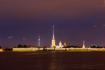Fototapeta na wymiar RUSSIA, SAINT PETERSBURG - AUGUST 18, 2017: View on the Peter and Paul Fortress, the river Neva, the steeple with a cross on a dark summer night