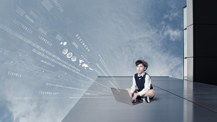 Child using laptop and digital information concept.