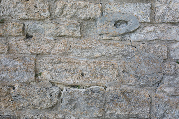 Old wall made of big stones and broken bricks. Vintage rough blocks surface background