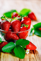 Fresh strawberries in a Cup on the table.