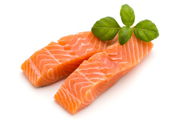 Fresh salmon fillet with basil on the white background.