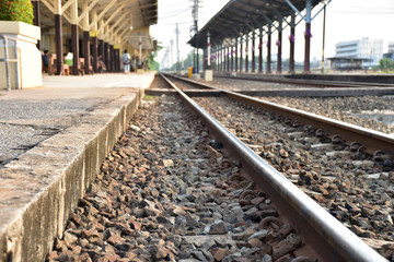 Fototapeta premium The long railroad at local platform. There is people wait for train come soon.