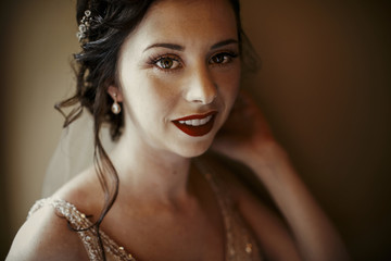Portrait of beautiful bride with dark lips and delicate curls