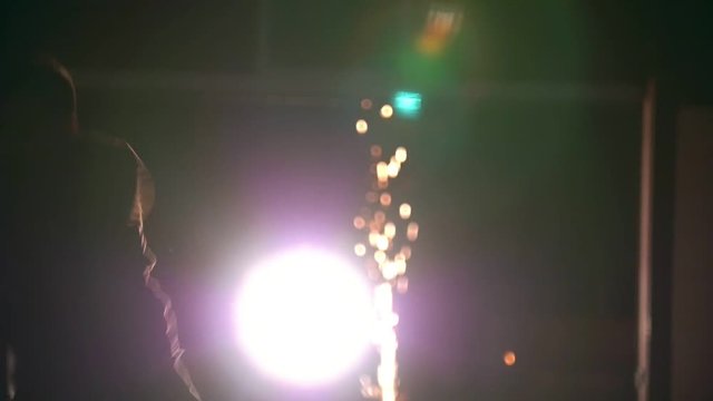 Night tricking, man jumps and makes a kick in the air with his foot