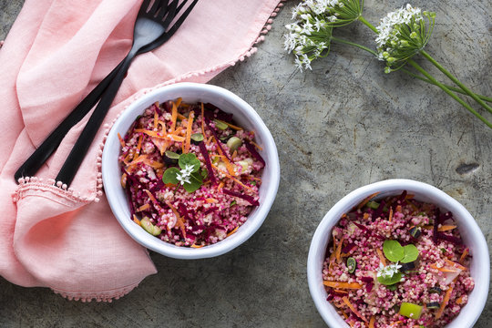 Pink and red Millet Salad in bowls with a pink napkin
